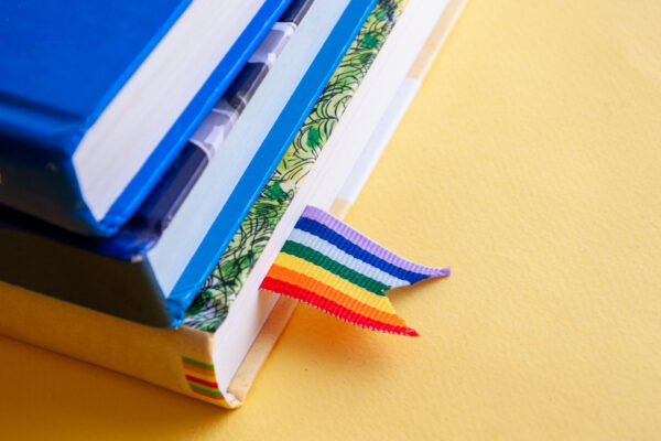 A,Stack,Of,Three,Books,With,Rainbow,Ribbon,Bookmarks,Is