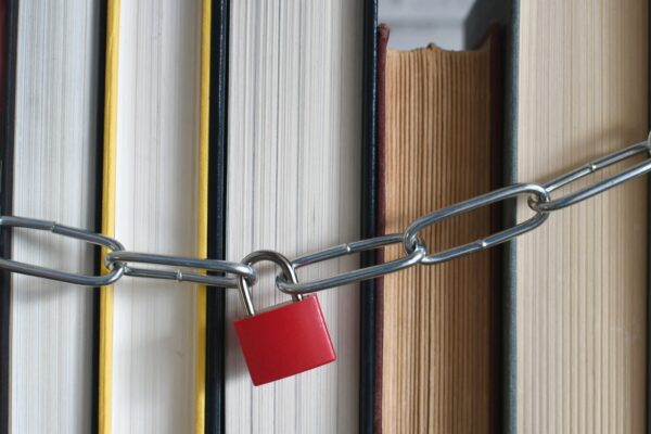 Padlock,And,Chain,Around,A,Stack,Of,Books,-,Concept