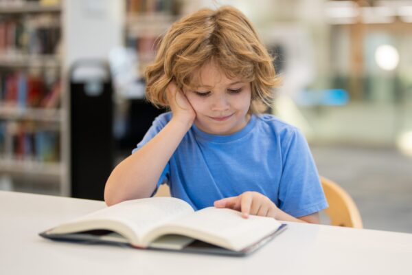 Kid,Reading,Book.,Child,Reading,Book,In,School,Library.,Learning