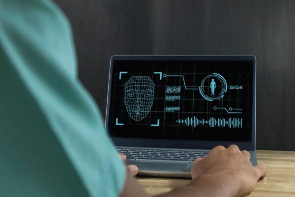 Deepfake,And,Artificial,Intelligence,Concept.,Man,Using,A,Laptop,To