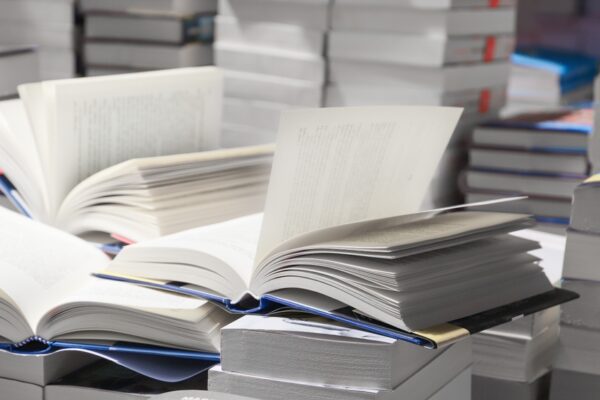 Stack,Of,Books,,Close,Up.,Open,Book,On,The,Table
