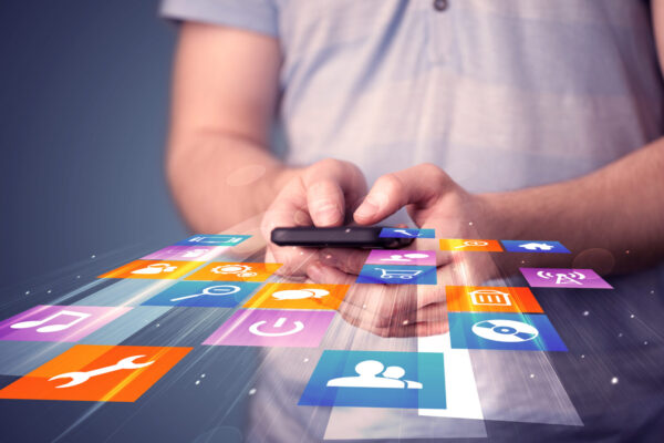 Man,Holding,Smart,Phone,With,Colorful,Application,Icons,Comming,Out