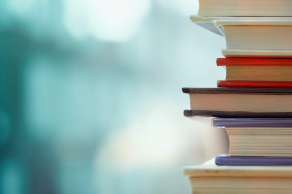 Book,Stack,In,The,Library,Room,And,Blurred,Bookshelf,For